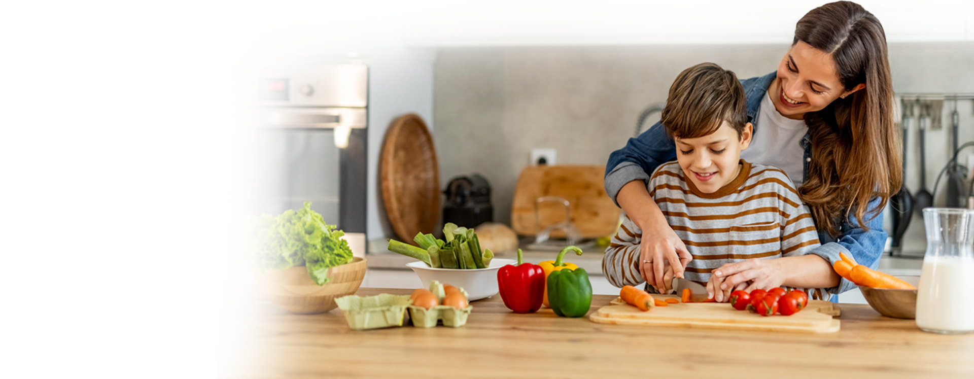 A mother and son preparing a meal together in the kitchen